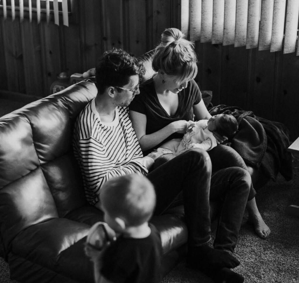 family with two children sitting on the couch