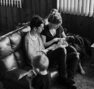 family with two children sitting on the couch